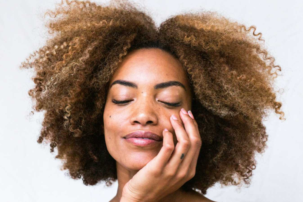 women with hand on her face and smooth skin