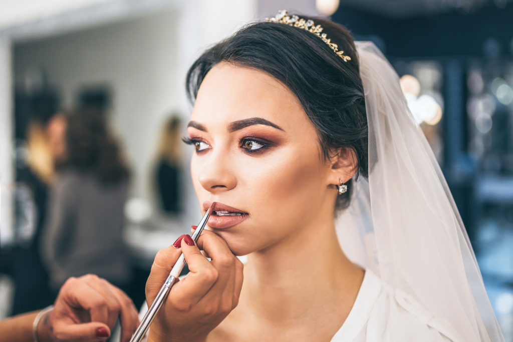 Pretty bride on makeup before weddiing