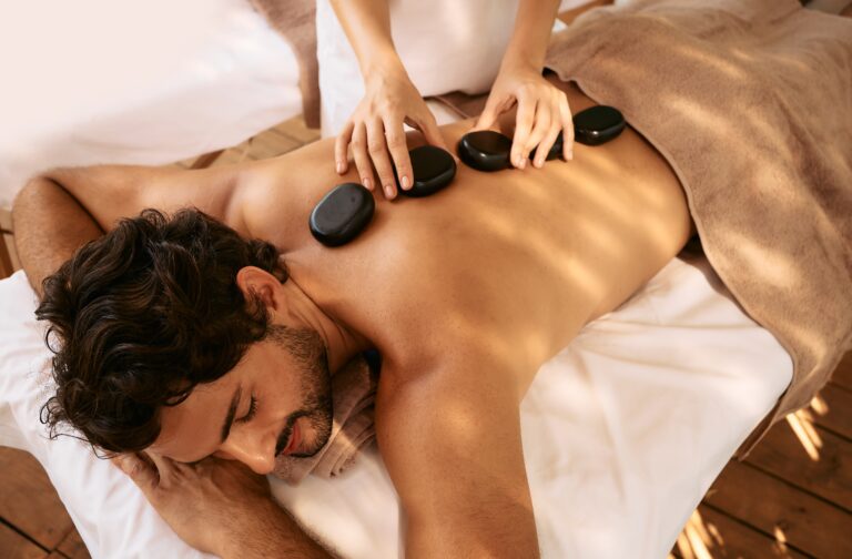 Handsome,Man,At,Spa,Resort,Receives,Hot,Stone,Massage.,Hot